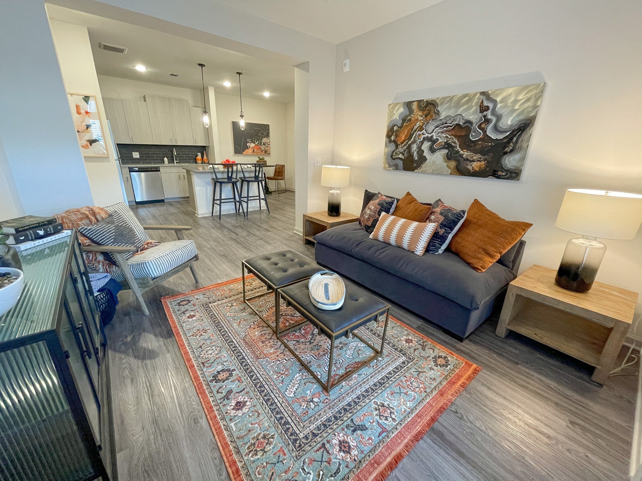 a living room and kitchen with a couch and a table